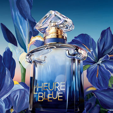 Guerlain L'Heure Bleue 2026 bottle framed by blue iris flowers