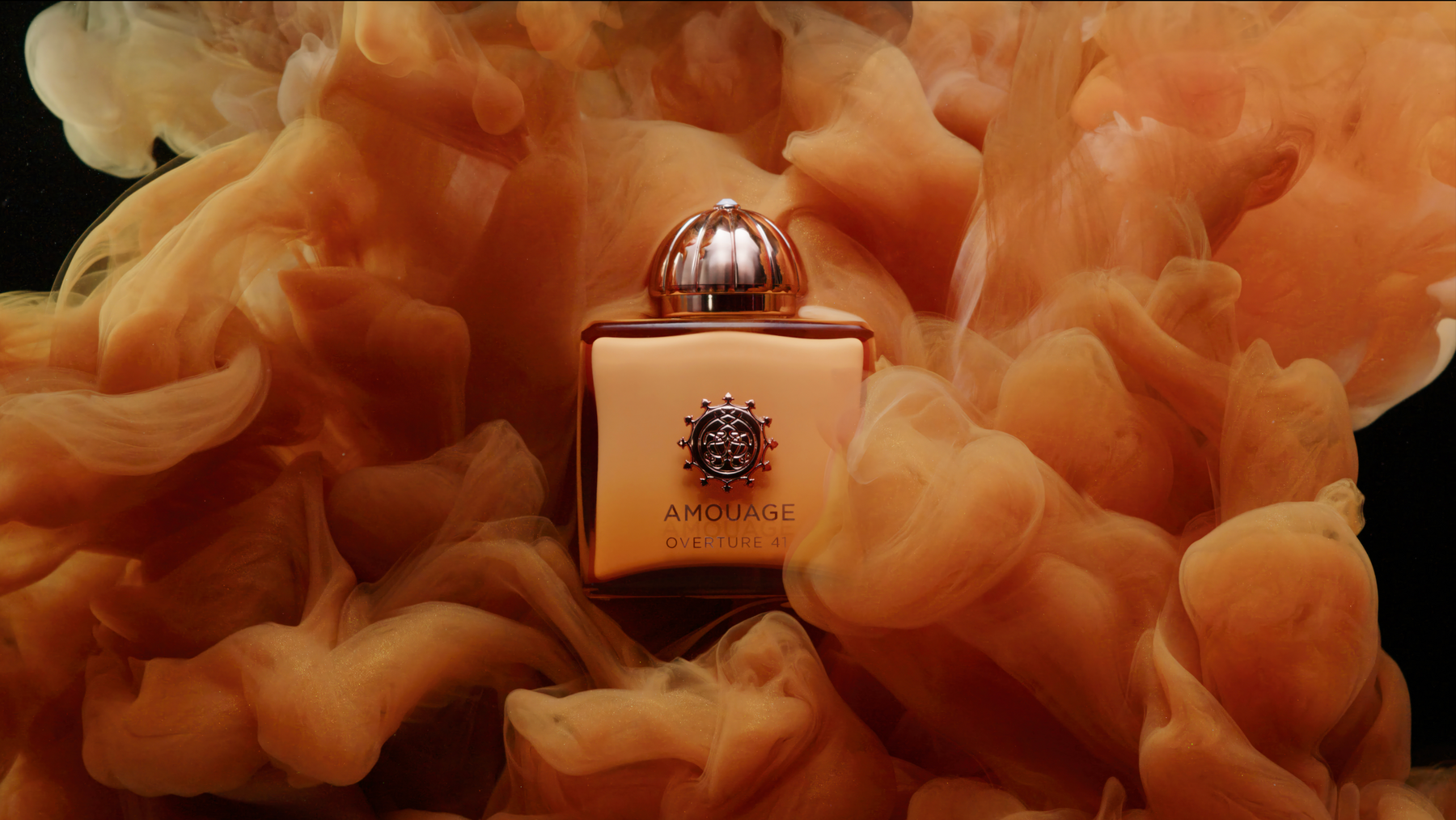 Amouage Overture 41 bottle surrounded by amber-colored clouds
